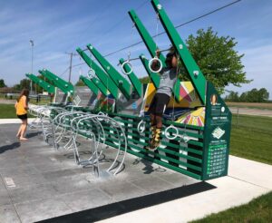 Outdoor exercise station with people using fitness equipment.