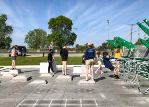 Children playing on outdoor fitness equipment.