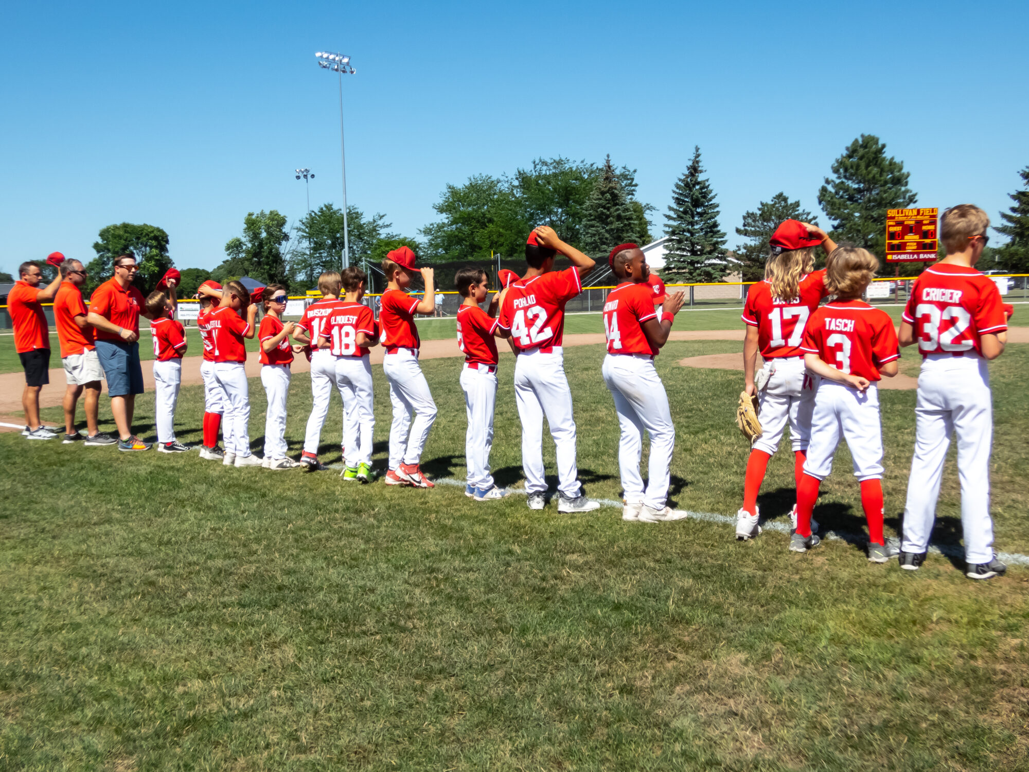 Youth baseball team lined up on field.