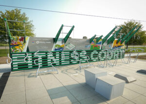 Outdoor fitness court with exercise equipment.