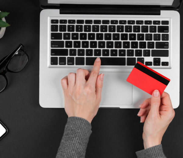 Person shopping online with credit card and laptop