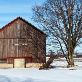 barn Rustic barn and silo in snowy landscape.