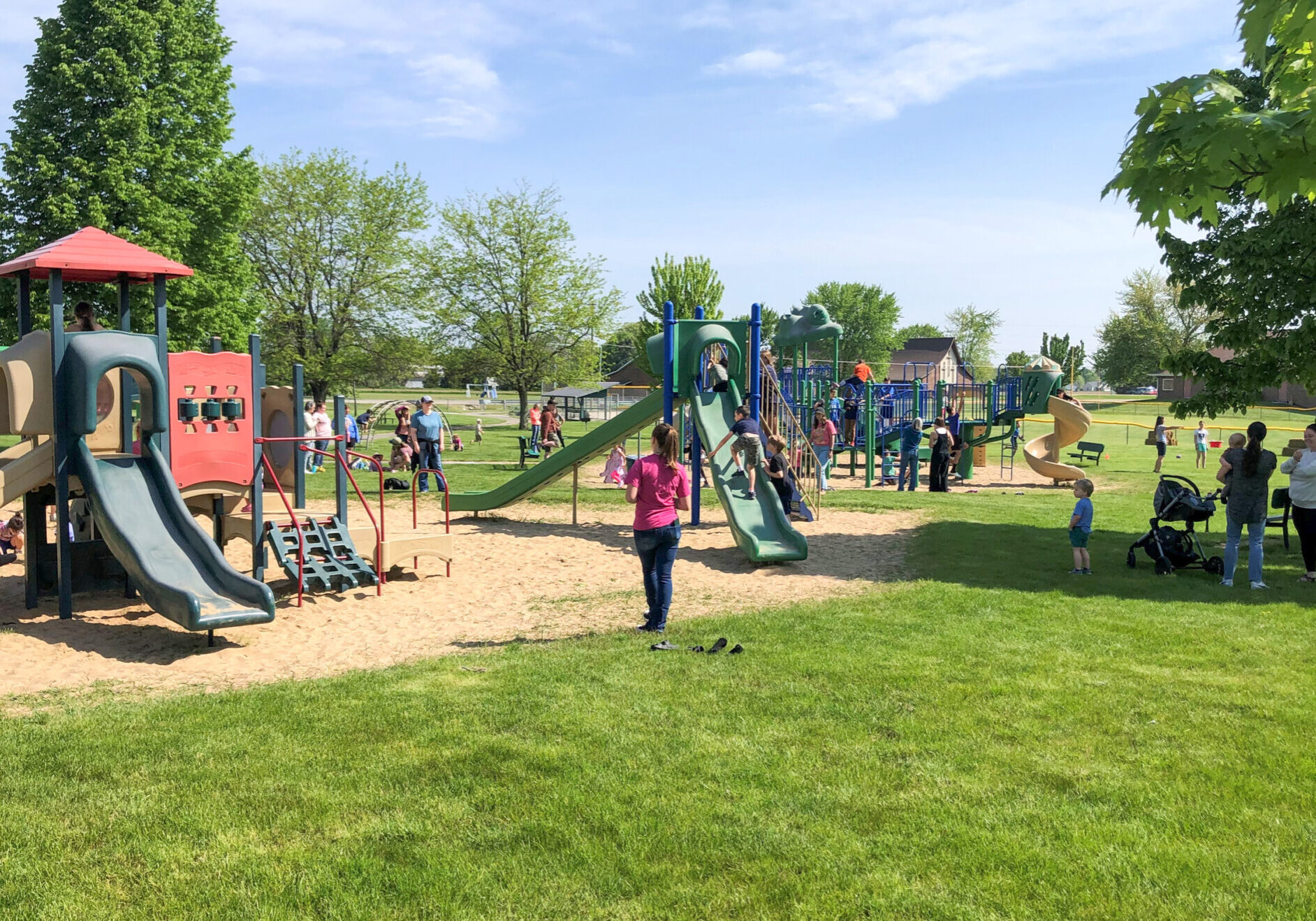 Children and adults at a colorful playground.