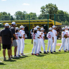 Youth baseball team standing on the field together.